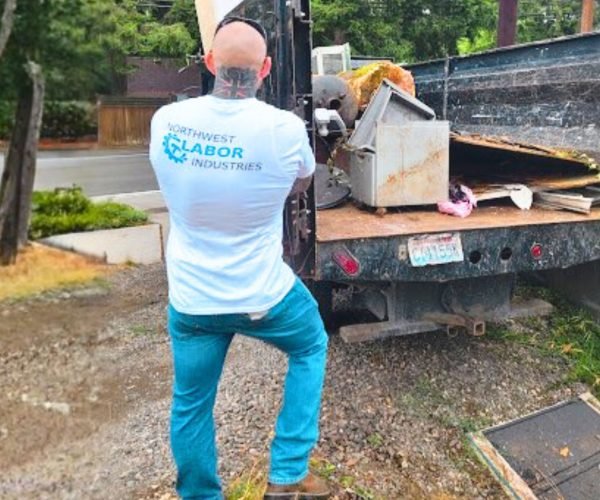 Junk removal truck picking up yard waste