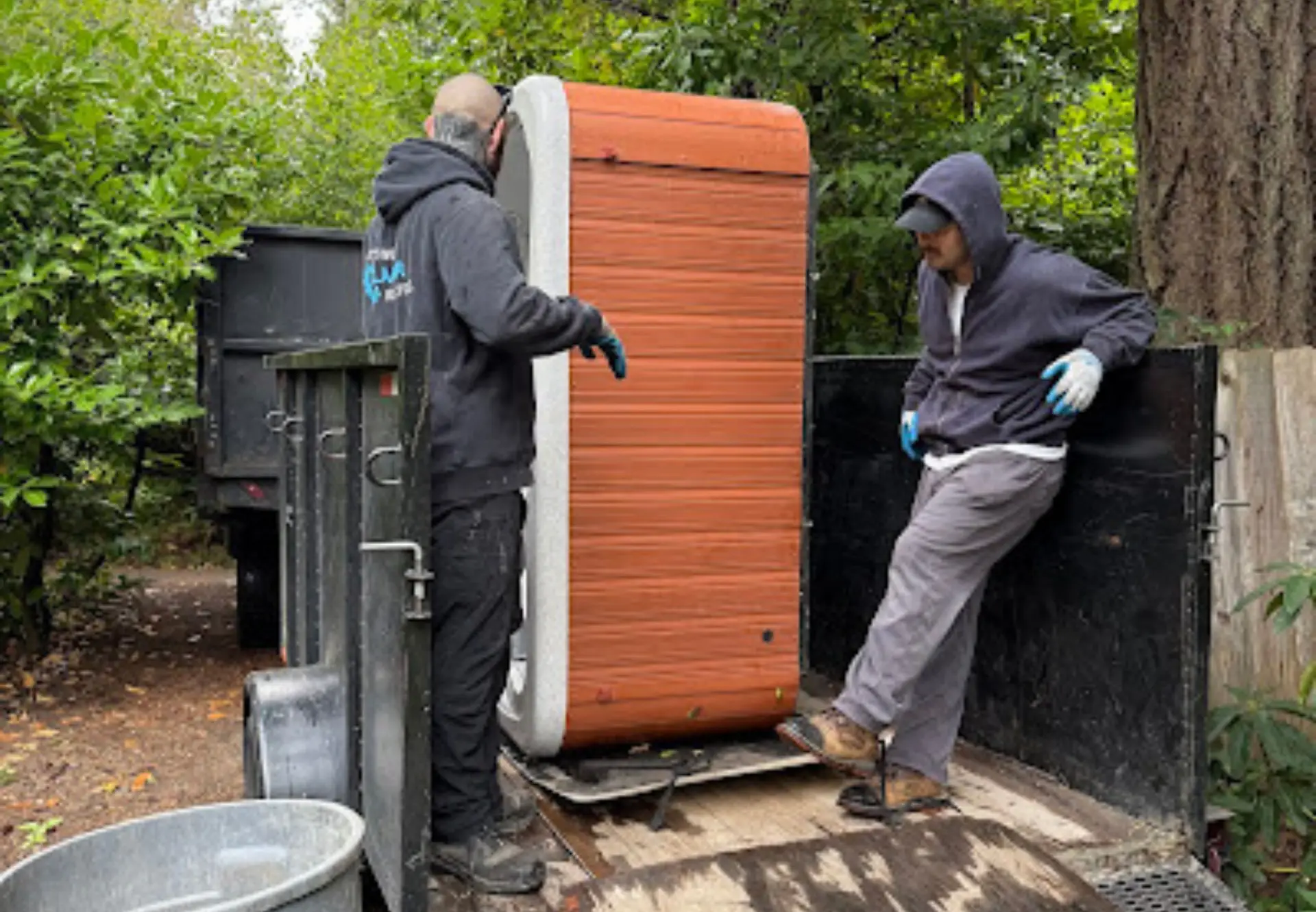 Hot tub removal truck transporting a dismantled hot tub