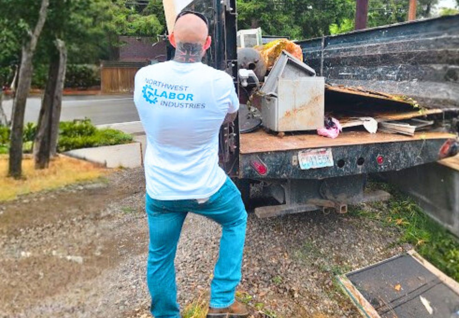 Junk removal truck picking up yard waste