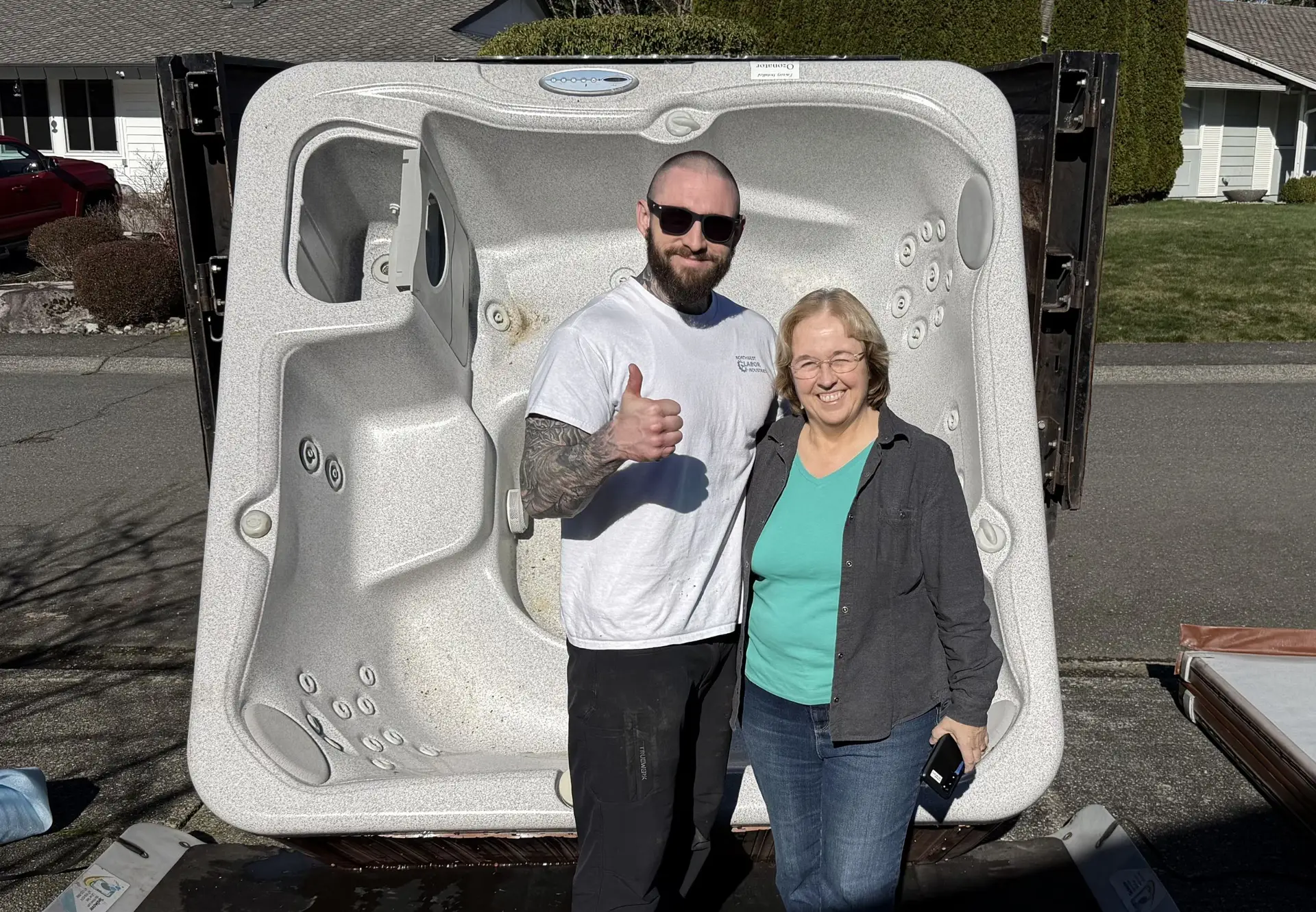 barnaby and a happy client in front of a big hot tub
